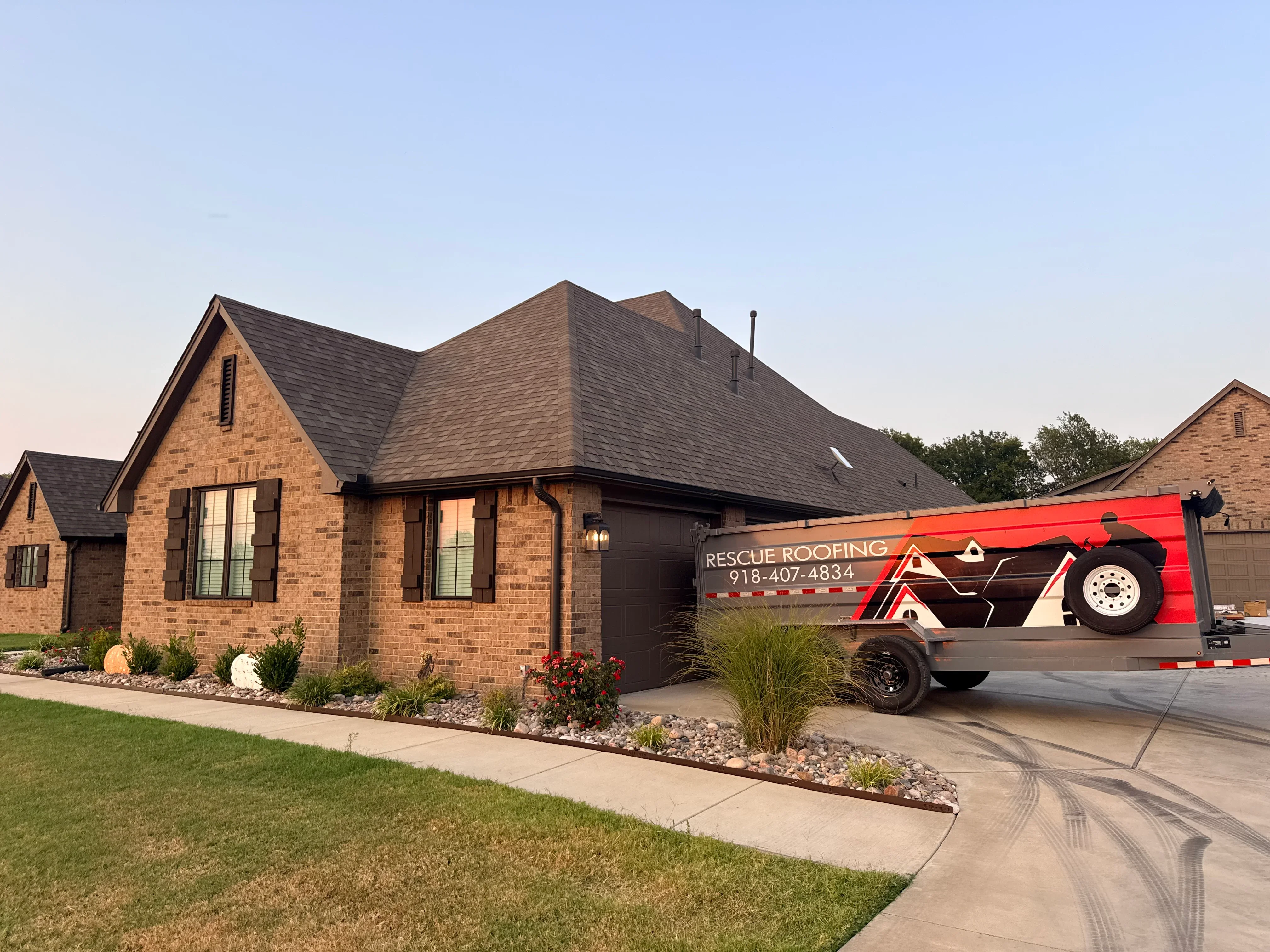 Brick home with new charcoal gray architectural shingle roof installation