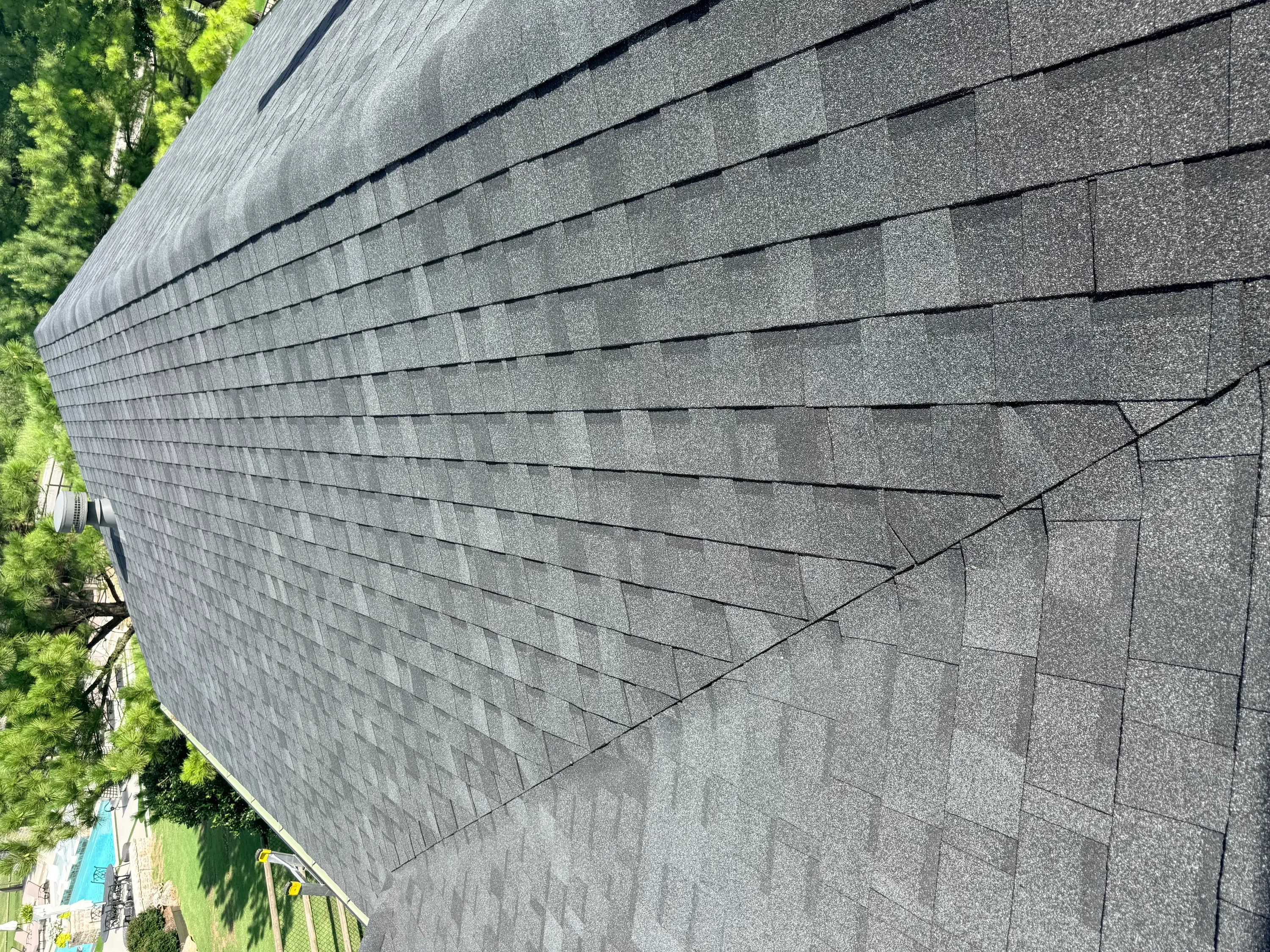 Charcoal gray dimensional asphalt shingles installed with clean horizontal lines and proper overlap
