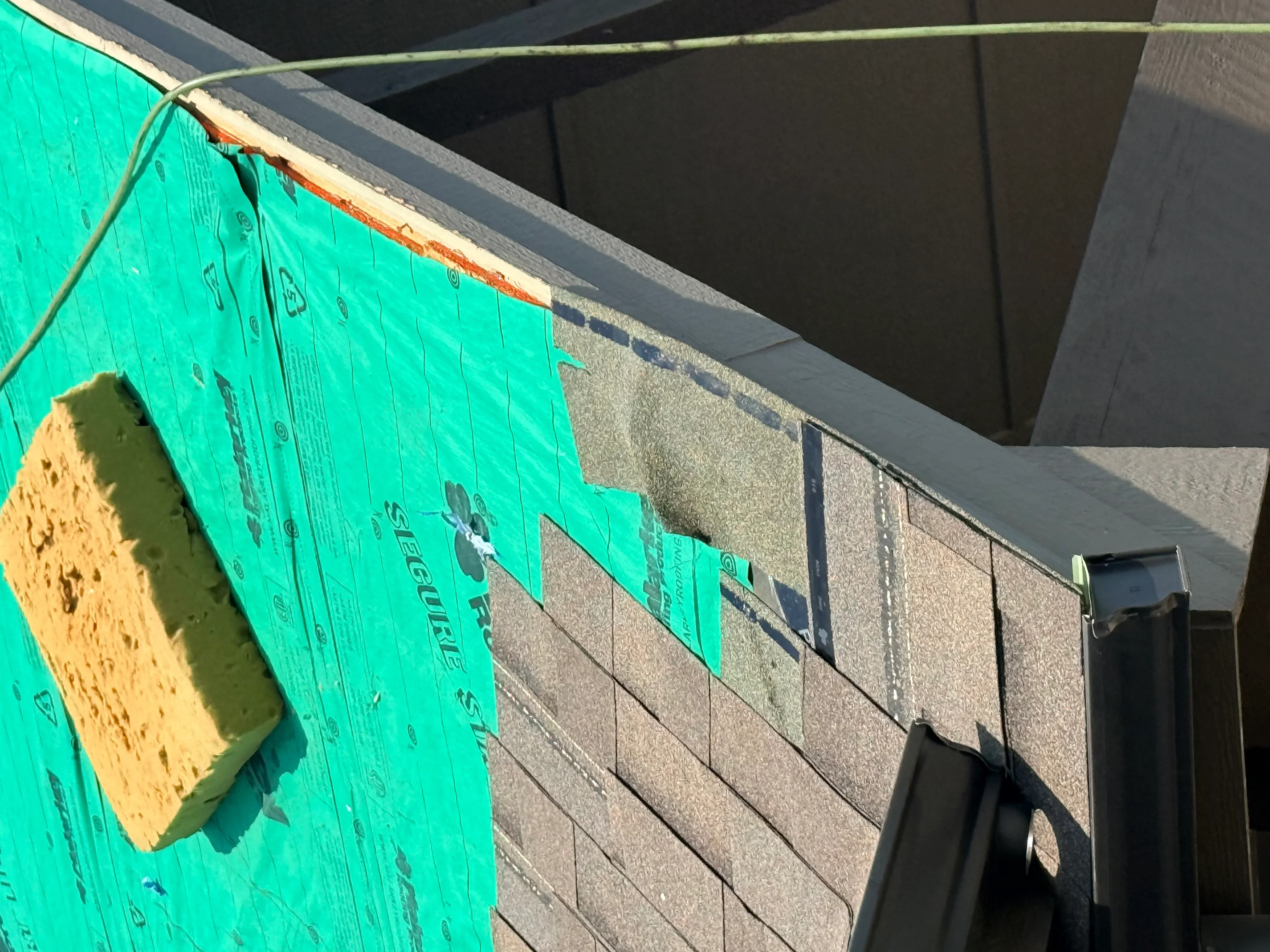 Green synthetic roof underlayment and sheathing installation with fasteners on residential roof structure