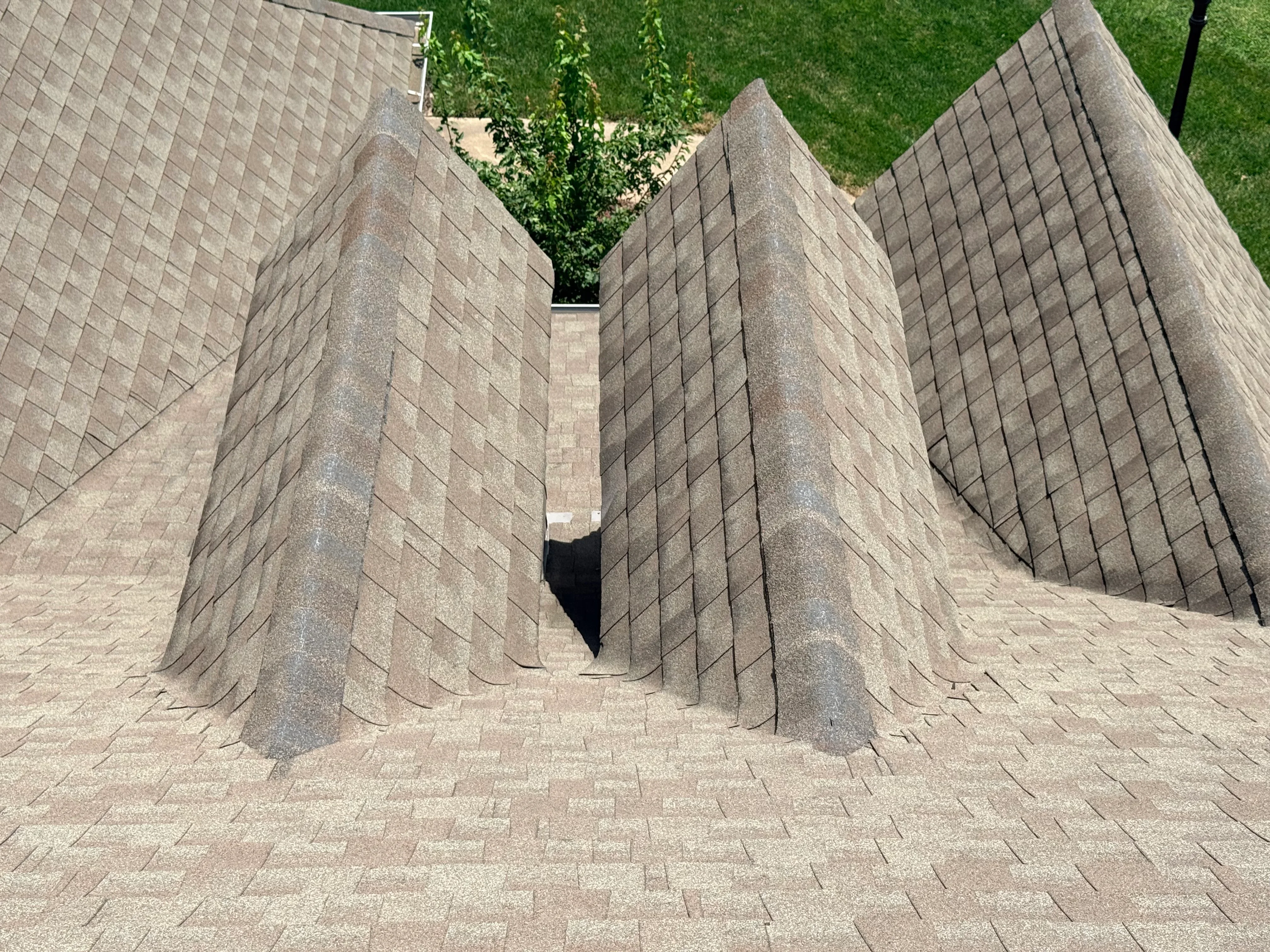 Gray dimensional asphalt shingles installed on multi-pitched residential roof with clean lines