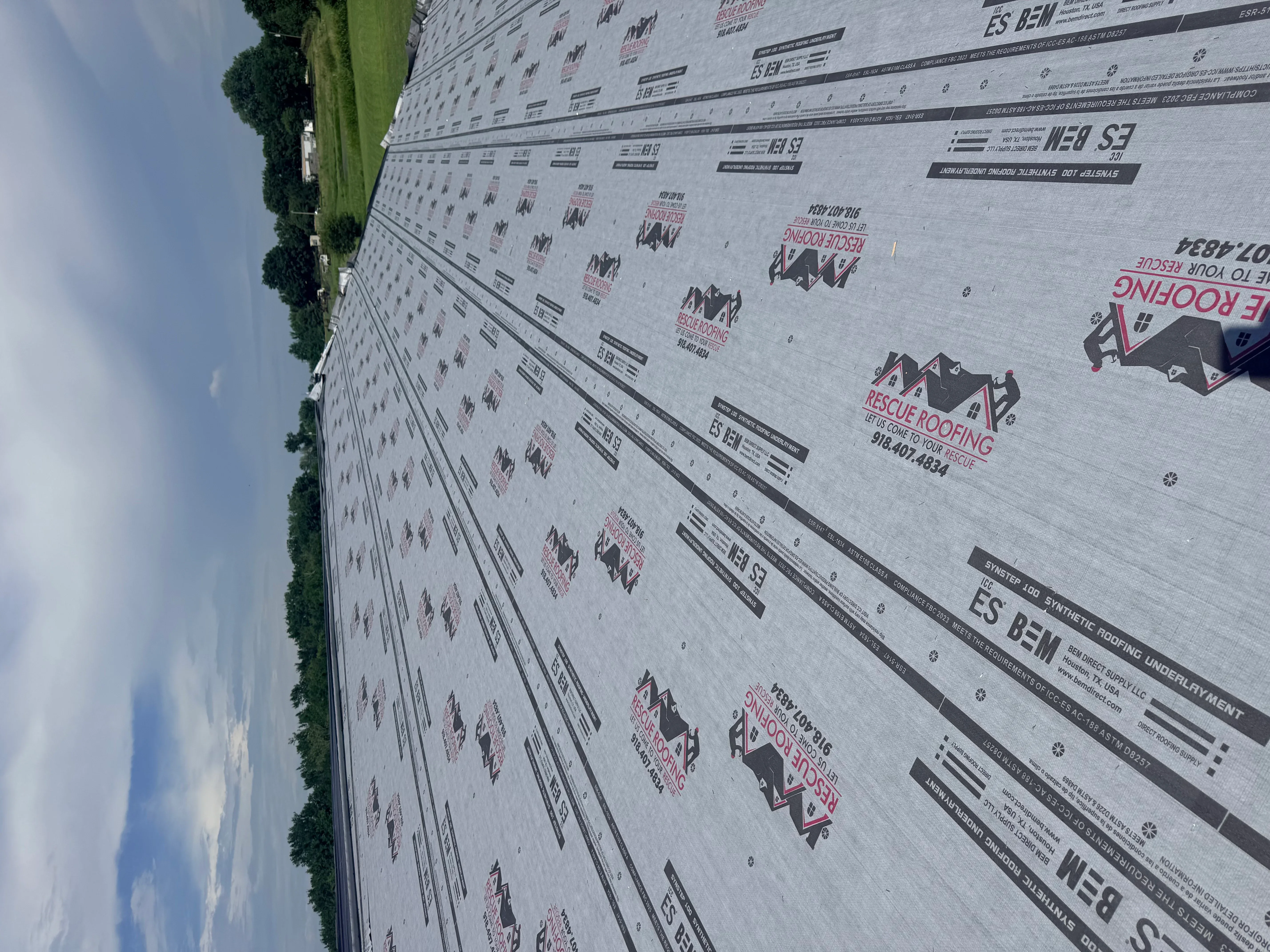 Synthetic roof underlayment with fastening pattern and product specifications installed on residential roof deck