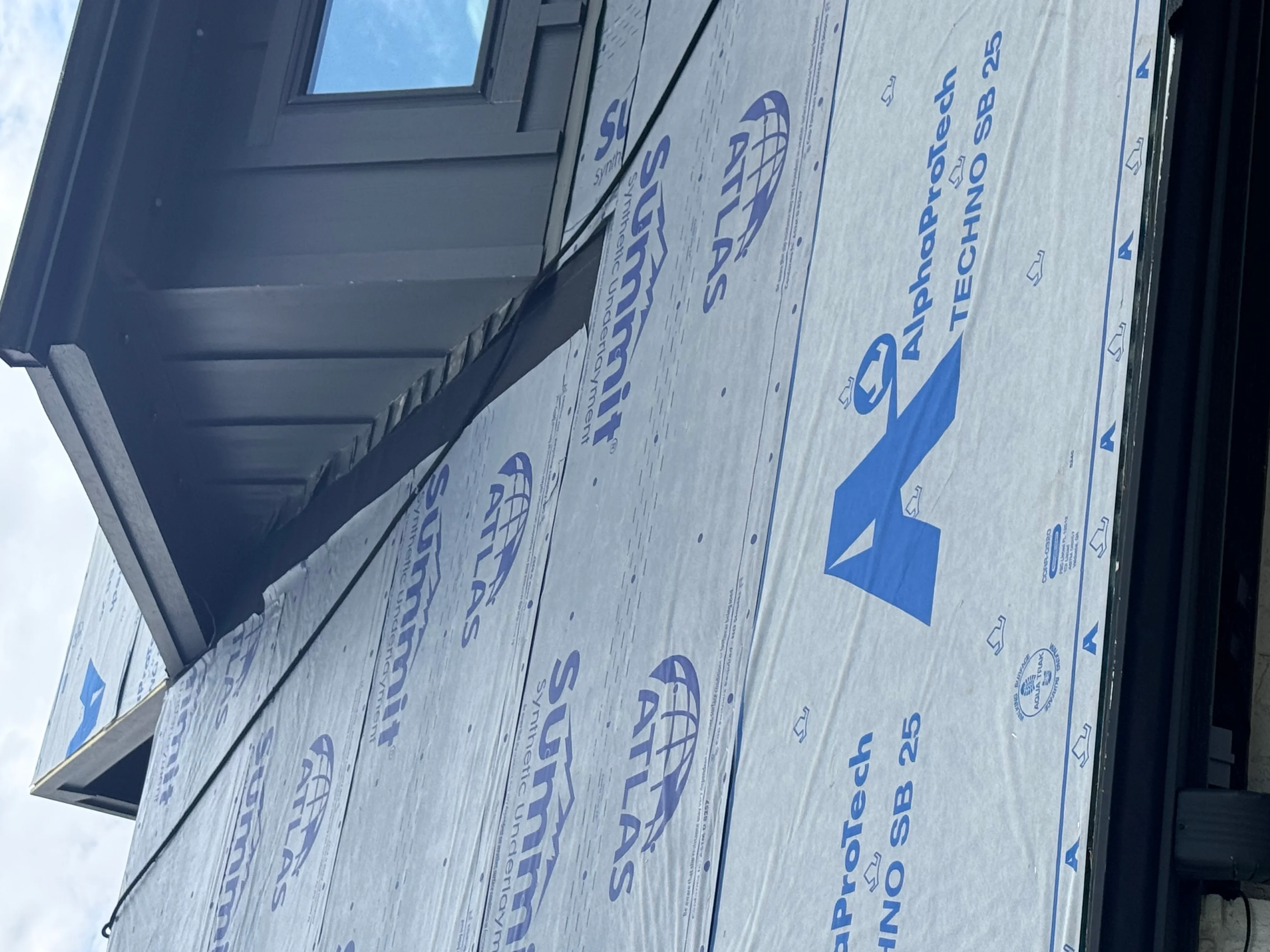 Synthetic roof underlayment installed on sheathing with proper fastening and overlap