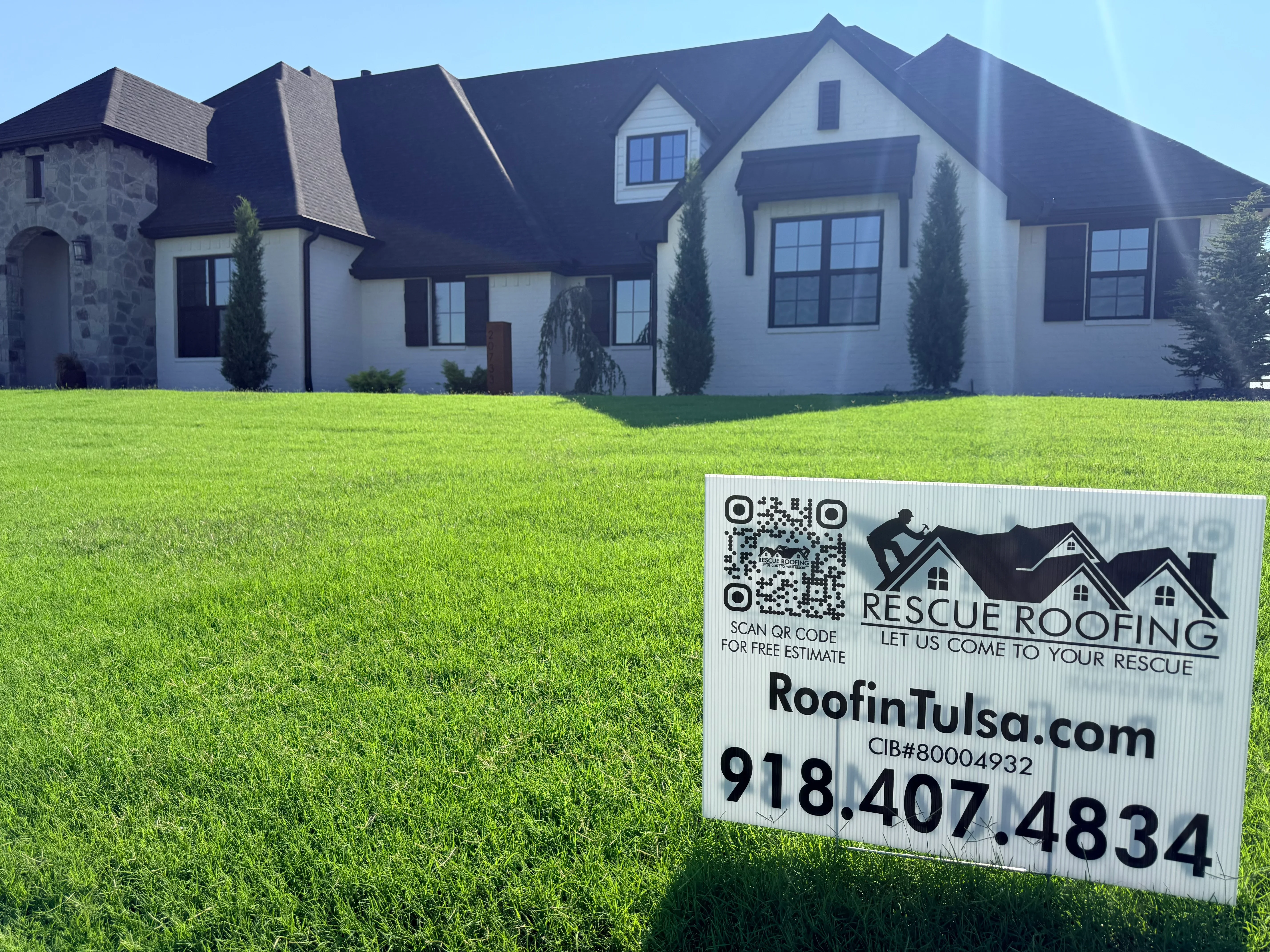 Dark architectural shingles on multi-gable residential roof with dormers and complex roofline